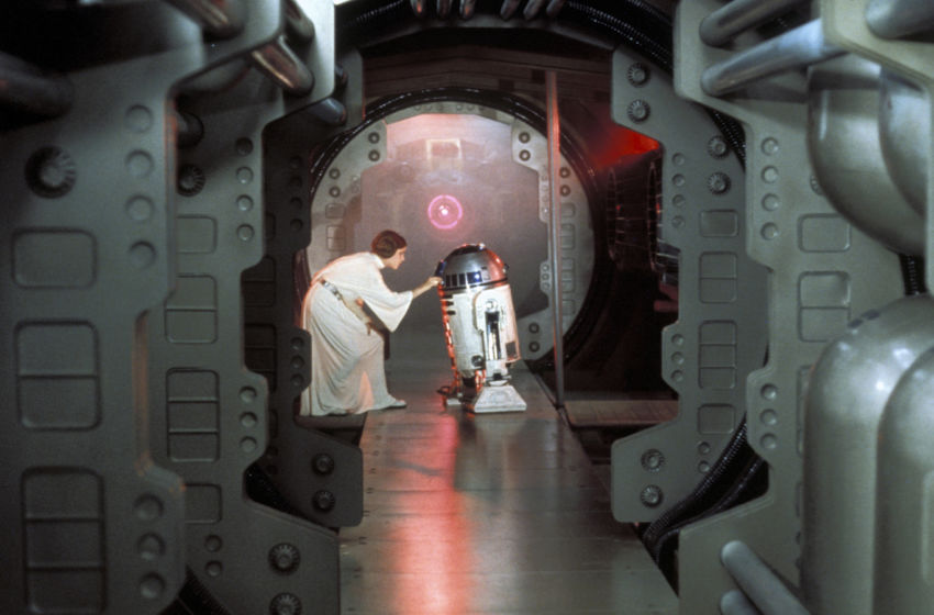 Princess Leia (Carrie Fisher) loads the plans for the Death Star battle station with a plea for help to Obi-Wan Kenobi into R2-D2 on the Rebel Blockade Runner.