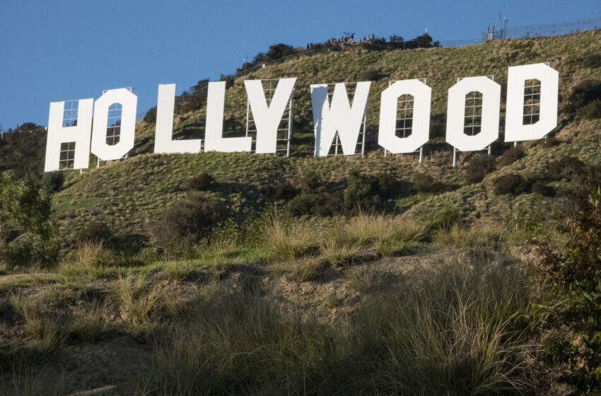 LOS ANGELES, CALIFORNIA - DECEMBER 15: Tourists hike to the Hollywood sign on December 15, 2019, in Los Angeles, California. Originally created in 1923 as a temporary advertisement for a local real estate development, the Hollywood sign has become an American landmark and cultural icon. (Photo by Paul Rovere/Getty Images)